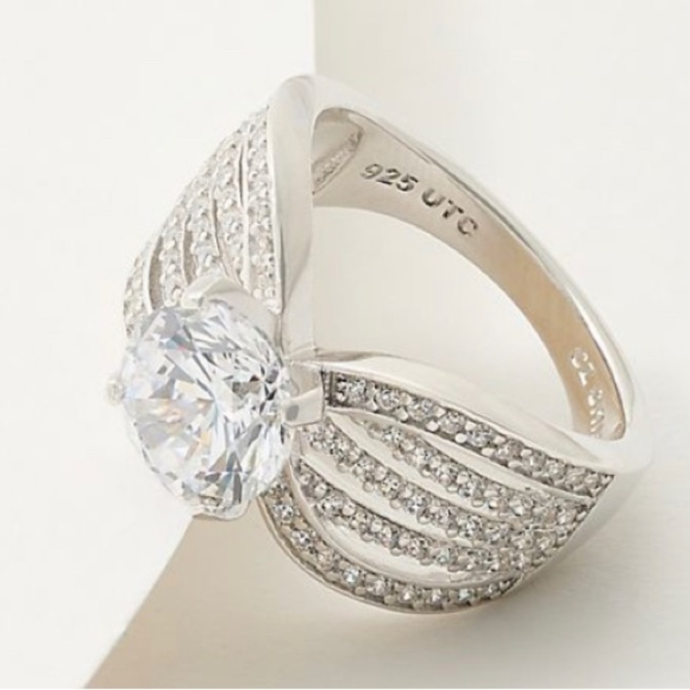 A QVC Diamonique .925 sterling silver CZ , and pave stone ring in size 8 .
